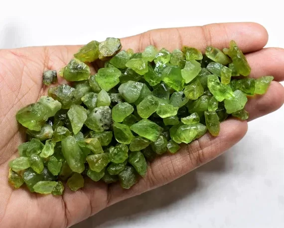 handful of raw arizona peridot rough gemstones