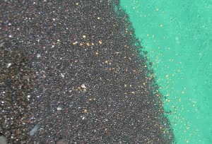 Black sands in gold pan, commonly associated with gold deposits