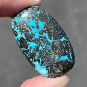 cabochon of morenci turquoise with silvery pyrite matrixing