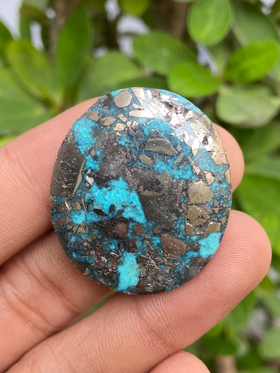 large round cabochon of morenci turquoise gemstone