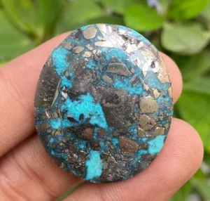 large round cabochon of morenci turquoise gemstone