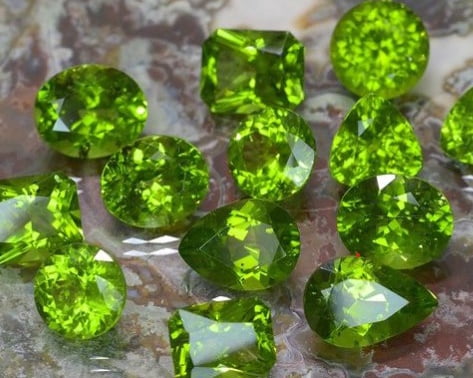 faceted arizona peridot gemstones in different cuts