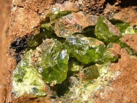 large rock crevice full of rough arizona gemstone peridot